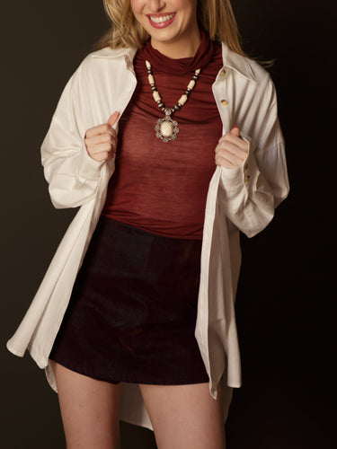 Dina Oversized Button Up with collared neckline, long sleeves, button front, button cuffs, chest pocket, oversized fit, and long length.