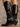 Pair of tall crocodile-embossed boots with a pointed toe, Western-style ankle buckle, pull-on tabs, cushioned footbeds, and a 13" shaft height.