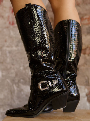 Pair of tall crocodile-embossed boots with a pointed toe, Western-style ankle buckle, pull-on tabs, cushioned footbeds, and a 13" shaft height.