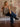 Model wearing mid-rise wide-leg jeans with exposed side seams, a button and zipper closure, and classic 5-pocket design with stretch.