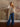 Model wearing mid-rise wide-leg jeans with exposed side seams, a button and zipper closure, and classic 5-pocket design with stretch.