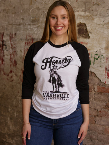 Lightweight raglan long sleeve graphic tee with Howdy print and relaxed fit in 100% cotton.