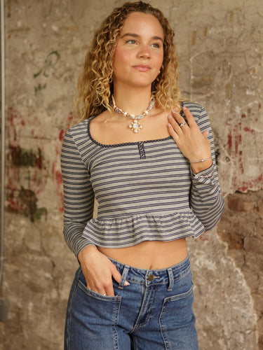 Striped long sleeve peplum top with square neck, functional snap buttons, cropped length, and stretchy lightweight fit.