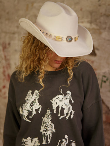 Faux suede Western-style hat with concho belt strap and adjustable inner cinch.