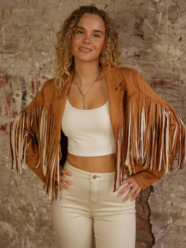 Cropped faux suede fringe jacket with lapel collar, long sleeves, lining, and stretch.