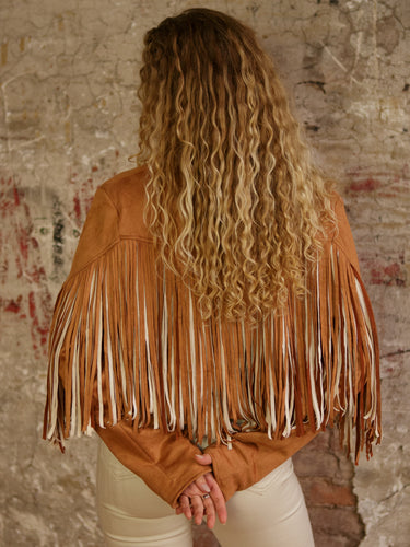 Cropped faux suede fringe jacket with lapel collar, long sleeves, lining, and stretch.