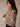 Cropped faux fur leopard coat with collar, long sleeves, and relaxed fit.