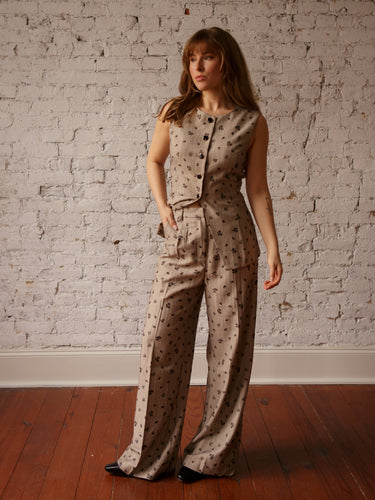 Mid-rise pleated pants with button and zipper closure, belt loops, front pockets, and dainty floral print.