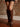 Knee-high faux leather western-inspired boots with embossed stitching, inner zipper, cushioned footbed, and 2.5-inch block heel.