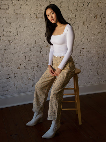 High rise floral barrel-leg jeans with button and zipper closure, belt loops, and 5-pocket design.