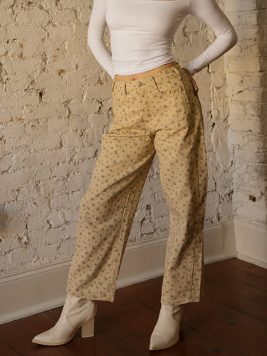 High rise floral barrel-leg jeans with button and zipper closure, belt loops, and 5-pocket design.