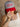 Trucker-style hat with red brim, embroidered front, and plastic adjustable snap closure.
