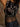 Sleeveless cropped vest with v-neck, sequin detailing, two button accents, fringe, and stretch.