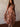 Fleur Long Sleeve Dress with high neck, long sheer sleeves, drop waist, floral print, asymmetrical hem, pull-on design, and midi length.