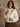 Helena Fuzzy Coat with round neck, long sleeves, hook & eye closures, front patch pockets, faux fur exterior, lined shell, and normal length.