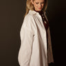 Dina Oversized Button Up with collared neckline, long sleeves, button front, button cuffs, chest pocket, oversized fit, and long length.