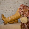 Faux leather boots with round toe, side zipper, and low heel.