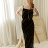 Textured velvet maxi dress with cowl neckline, adjustable spaghetti straps, and slip-style silhouette.