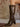 Pair of knee-high faux leather boots with a pointed toe, side zipper, cushioned footbed, and mid block heel.