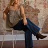 Model wearing mid-rise wide-leg jeans with exposed side seams, a button and zipper closure, and classic 5-pocket design with stretch.