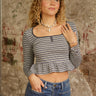 Striped long sleeve peplum top with square neck, functional snap buttons, cropped length, and stretchy lightweight fit.