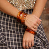 Acrylic amber swirl bangle available in round, square, or twist styles; sold individually.