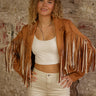 Cropped faux suede fringe jacket with lapel collar, long sleeves, lining, and stretch.