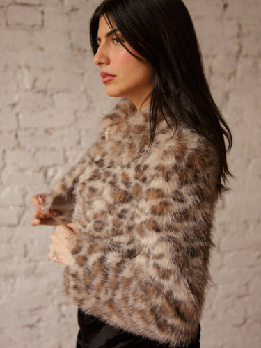 Cropped faux fur leopard coat with collar, long sleeves, and relaxed fit.