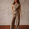 Mid-rise pleated pants with button and zipper closure, belt loops, front pockets, and dainty floral print.