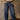 High rise barrel-leg pants with adjustable drawstring, elastic waistband, patch pockets, baggy silhouette, and stretch.