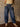 High rise barrel-leg pants with adjustable drawstring, elastic waistband, patch pockets, baggy silhouette, and stretch.