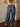 High rise barrel-leg pants with adjustable drawstring, elastic waistband, patch pockets, baggy silhouette, and stretch.