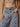 High rise wide leg jeans with elastic waistband, drawstring, button and zipper closure, belt loops, and large patch pockets.