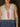 Sleeveless v-neck sweater vest with front tie closure, pearl accents, rib knit, lightweight, and relaxed fit.