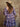 Plaid mini dress with sweetheart neckline, half sleeves, smocked bodice, tiered skirt, and stretchy fit.