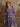 Plaid mini dress with sweetheart neckline, half sleeves, smocked bodice, tiered skirt, and stretchy fit.
