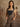 Sleeveless houndstooth jumpsuit with plunging neckline, button closure, belt loops, pockets, wide legs, and partial lining.