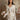 Long sleeve collared ruffle blouse with front tie closure and subtle shimmery embroidery. No stretch.