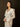 Long sleeve collared ruffle blouse with front tie closure and subtle shimmery embroidery. No stretch.