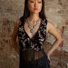 Sleeveless cropped vest with v-neck, sequin detailing, two button accents, fringe, and stretch.