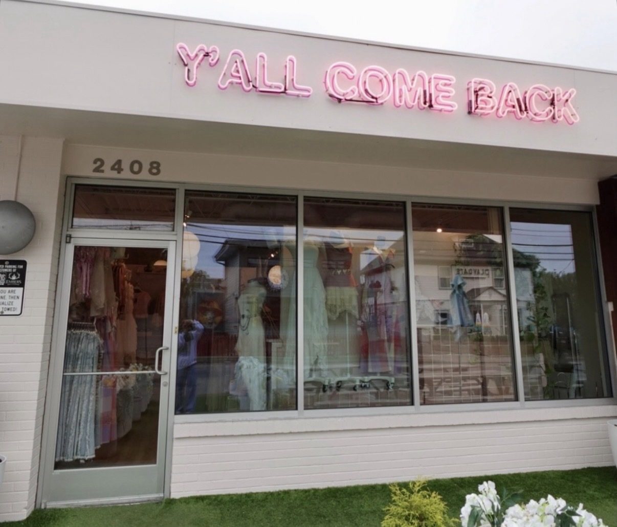Pink neon Y'all Come Back sign at the sister shop on 12th Avenue South